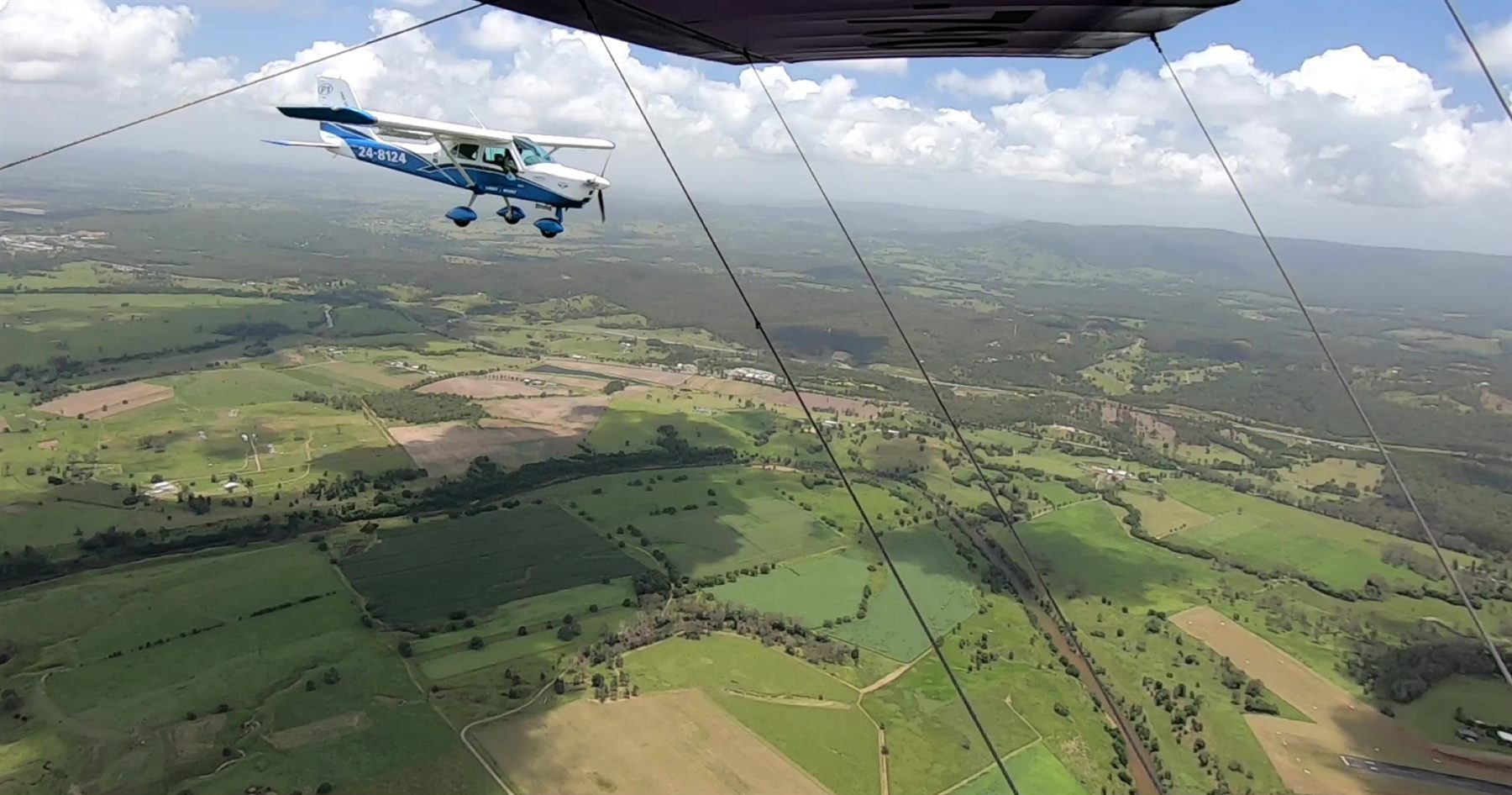 View from a light aircraft over green farmland near Gympie